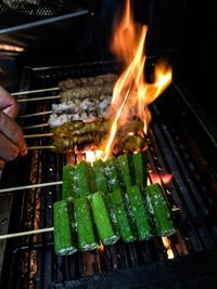 Close-up of man cooking on barbecue grill