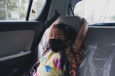 Portrait of young girl in car