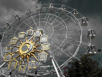 Low angle view of ferris wheel against sky