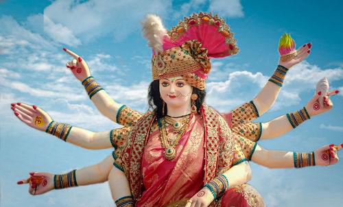 Low angle view of woman dancing against sky
