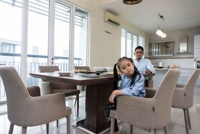 Portrait of friends sitting on table