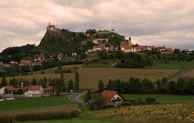 Houses on field against sky