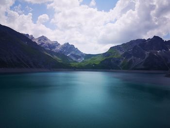 Scenic view of lake and mountains against sky