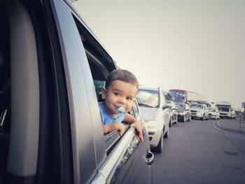 Cute boy sitting in car