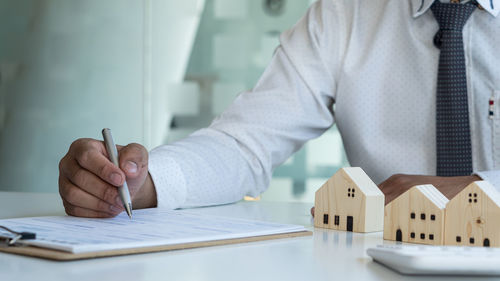 Midsection of man working on table