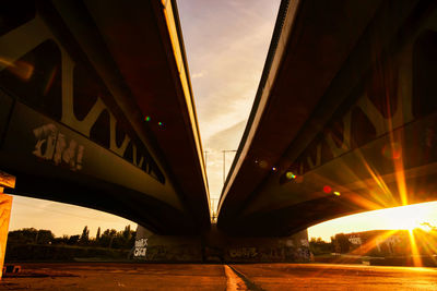 Low angle view of bridge against sky during sunset