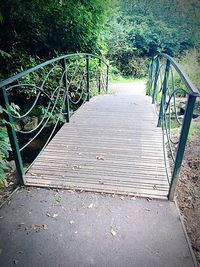 Empty footpath leading to railing