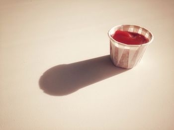 Close-up of drink on table against white background