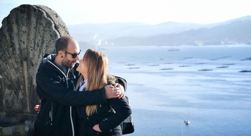 Couple standing by sea