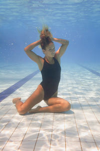 Full length of woman swimming underwater in pool