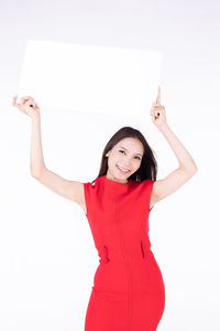 Portrait of a smiling young woman against white background