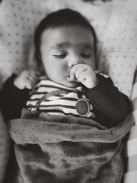 High angle view cute baby girl with eyes closed sleeping on bed