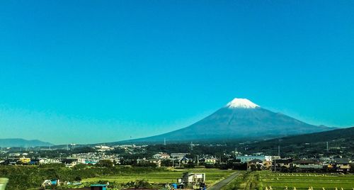 Scenic view of landscape against blue sky