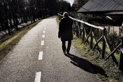 Shadow of woman on footpath