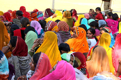 People in traditional clothing sitting outdoors