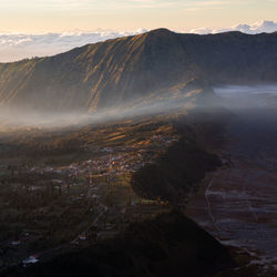 Some clouds cross the village of mount bromo