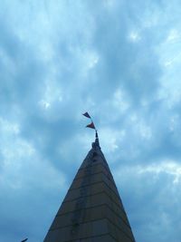 Low angle view of building against cloudy sky