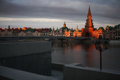 Bridge over river with buildings in background