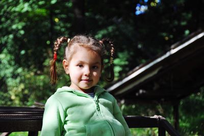 Portrait of cute girl sitting on bench