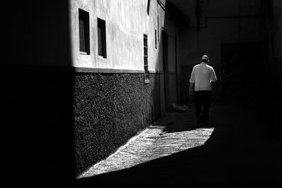Rear view of man walking on street