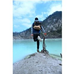 Rear view of man standing on cliff