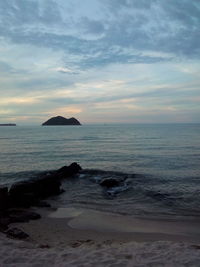 Scenic view of sea against cloudy sky