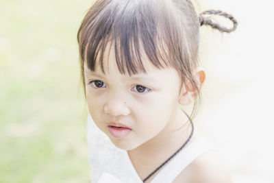 Close-up of cute girl looking away