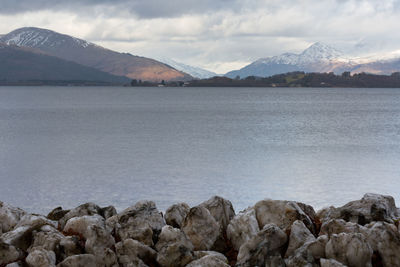 Scenic view of lake and mountains against sky