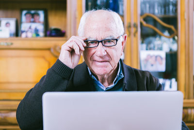 Close-up of man using mobile phone at home