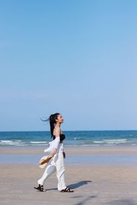 Full length of man on beach against sky