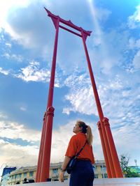 Low angle view of woman standing against sky