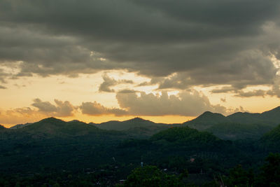 Scenic view of mountains against dramatic sky