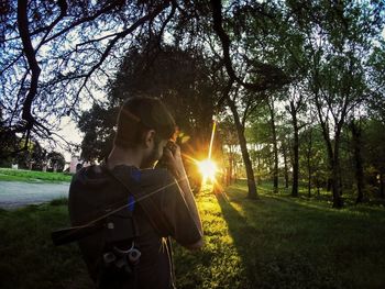 Man photographing at sunset