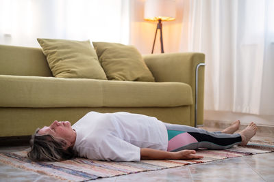 Young woman sleeping on bed at home