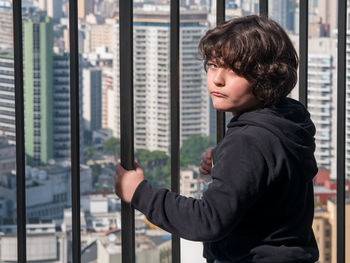 Portrait of man looking at city