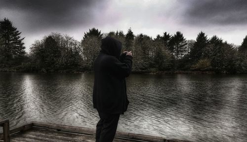 People standing by lake