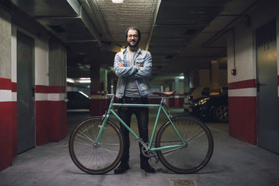 Young man with his fixie bike in a garage