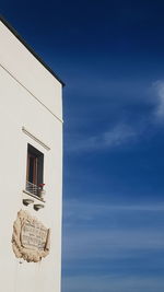 Low angle view of text on building against sky