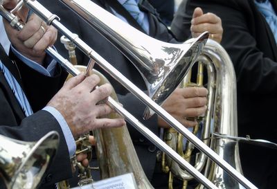 Midsection of man playing trumpet