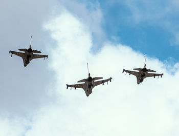 Low angle view of airplanes flying in sky