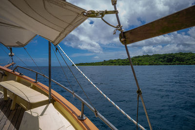 Sailboat sailing on sea against sky