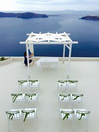 High angle view of empty chairs and tables at beach