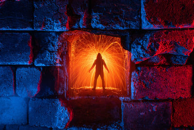 Rear view of man against red wall