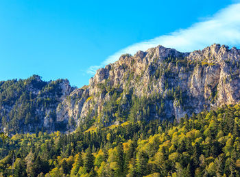 Scenic view of mountains against blue sky