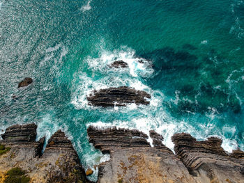 High angle view of rocks in sea