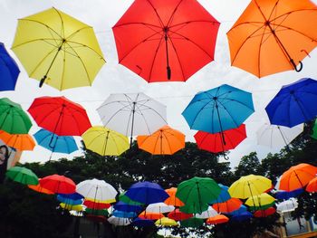 Low angle view of umbrellas against sky