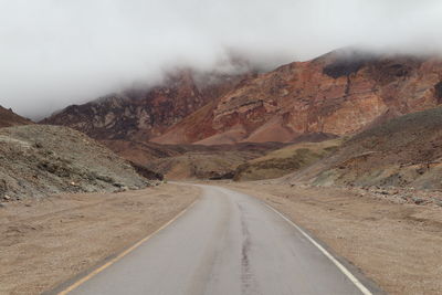 Road amidst mountain against sky