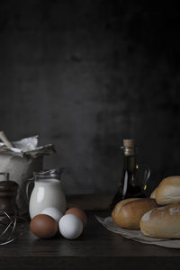 Flour with milk and eggs with a dark background