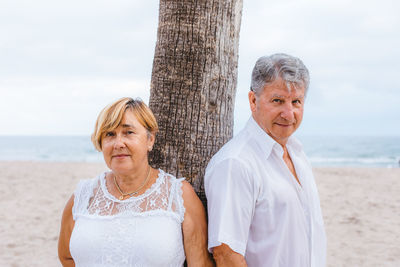 Portrait of a smiling young couple on beach