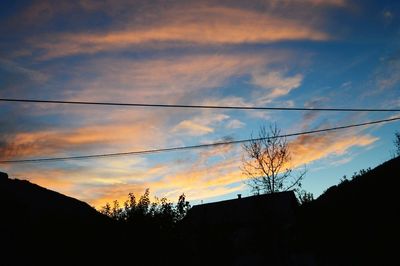 Low angle view of silhouette trees against sky during sunset